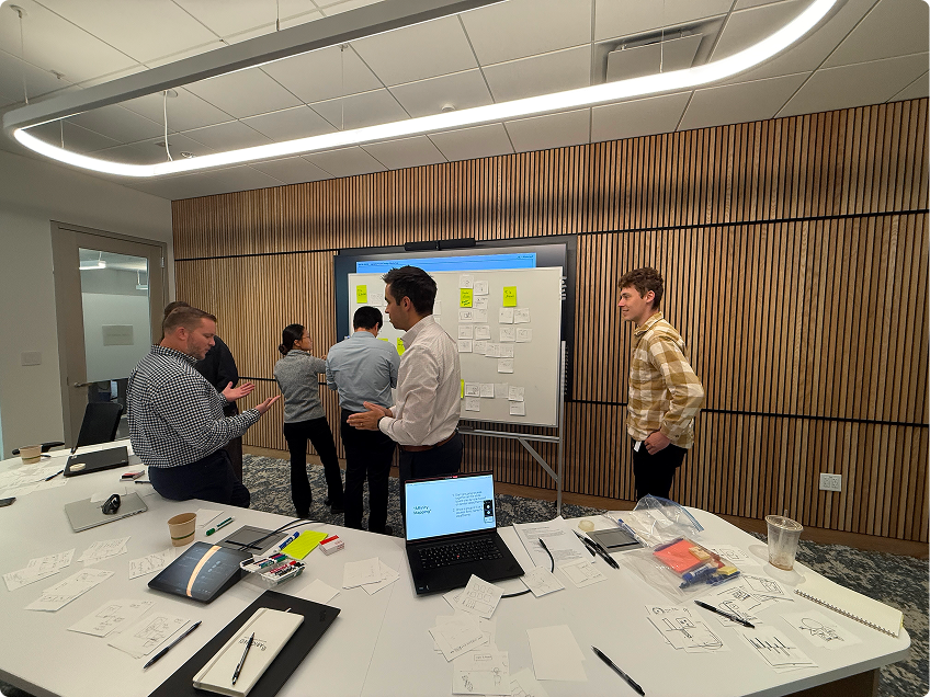 Team at whiteboard presenting concepts
